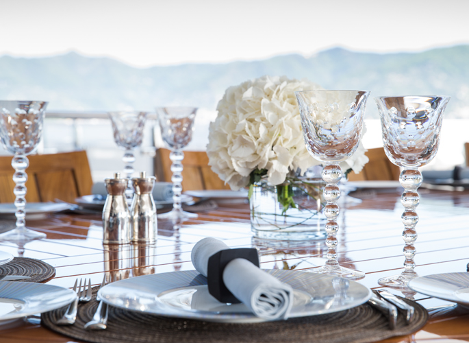 macro view of motor yacht Turquoise's outside dining table laid for entertaining