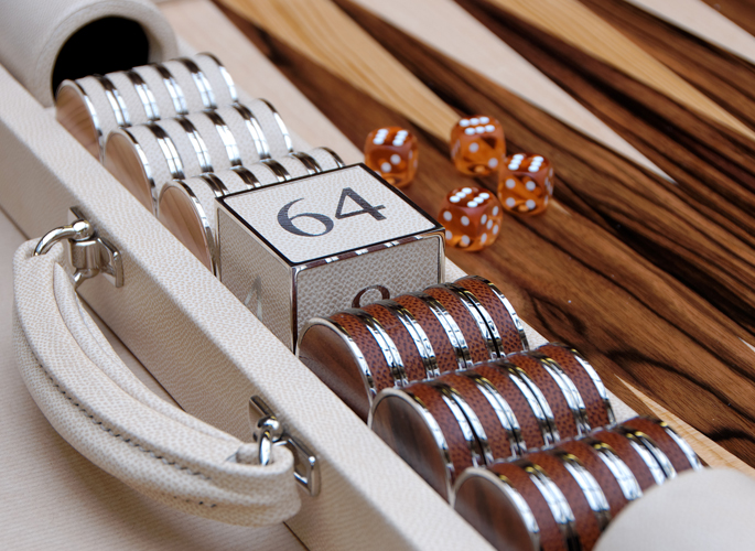 a leather and wooden backgammon set with sterling silver games pieces and a large dice