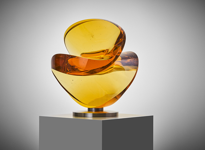 an abstract amber crystal art sculpture with curved features