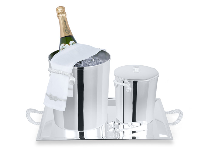 a sterling silver champagne and ice bucket with delicate serving table linen