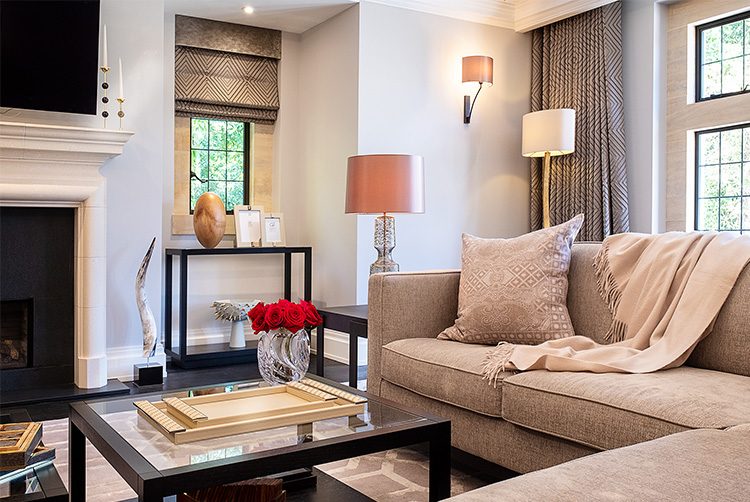 a sitting room with red roses a cashmere throw and luxury accessories