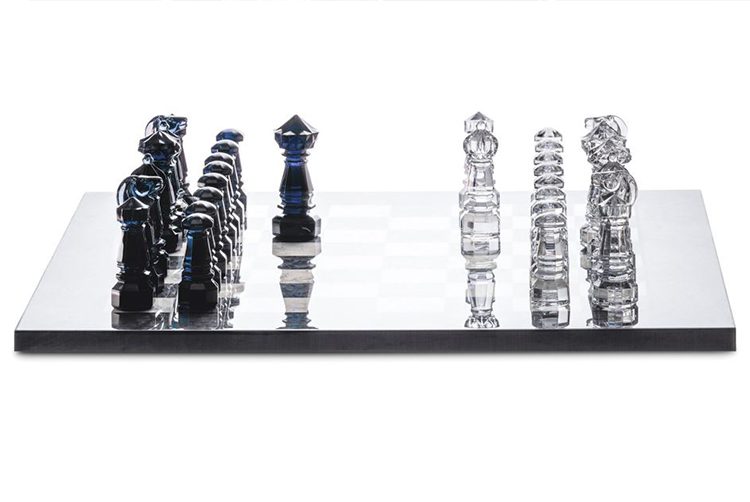 a showstopping chess set with dark blue and white crystal chess pieces