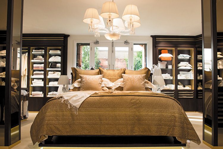 the stunning gold bed and chandelier in Glancy Fawcett's showroom