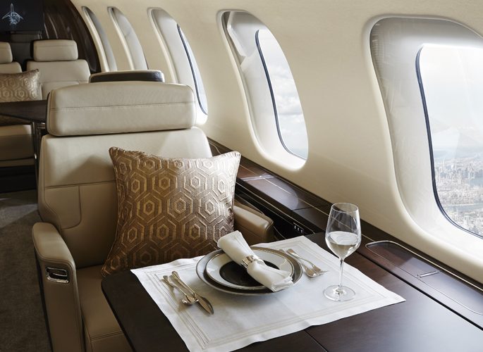 a private aircraft dining table by the window with luxury tableware