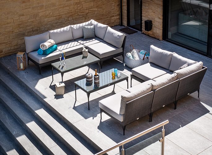a sunny deck area with champagne and crystal glasses