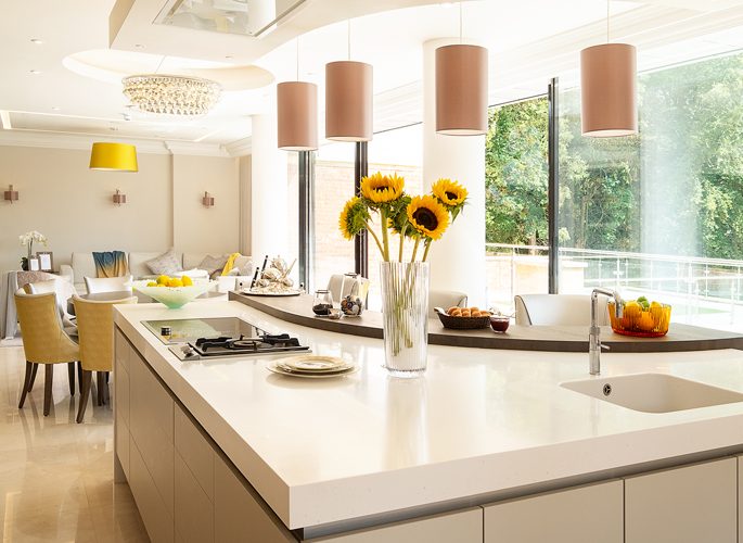 an open plan kitchen with accessories on the counter and yellow decor