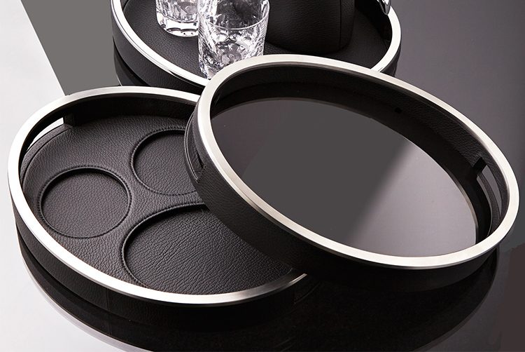 a black leather serving tray with a water jug and glass set on top