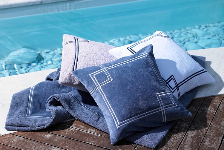 blue and grey exterior towels and cushions next to a pool
