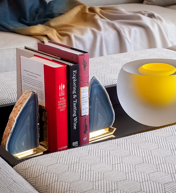 book ends made from precious stone and a yellow crystal contemporary case on a table