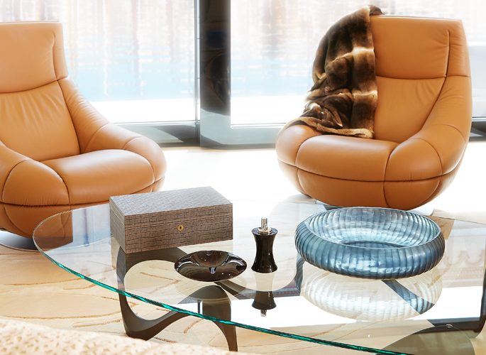 a superyacht's sitting room with a fur throw and a large decorative blue bowl