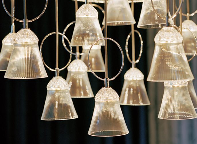 a multi-faced chandelier light that is glowing