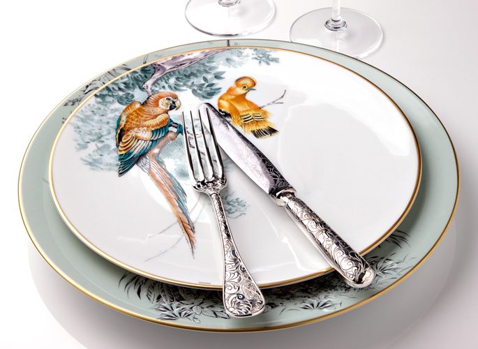 hermes porcelain plate with intricate decorative detail such as parrots in trees