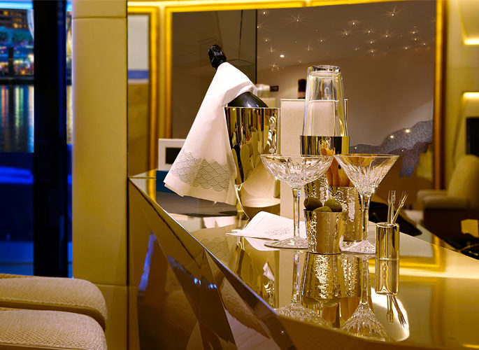 a superyacht bar set with a champagne bucket and crystal martini glasses