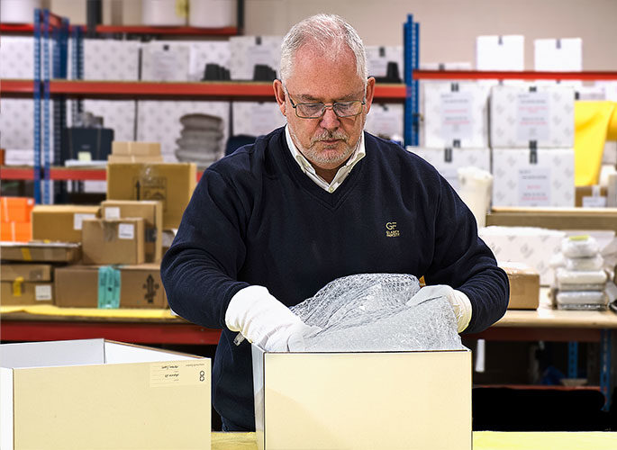 Logistics team carefully packing luxury product