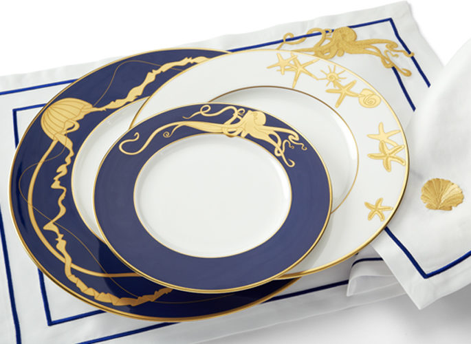 porcelain and matching table linen with gold sea creatures and blue embroidery