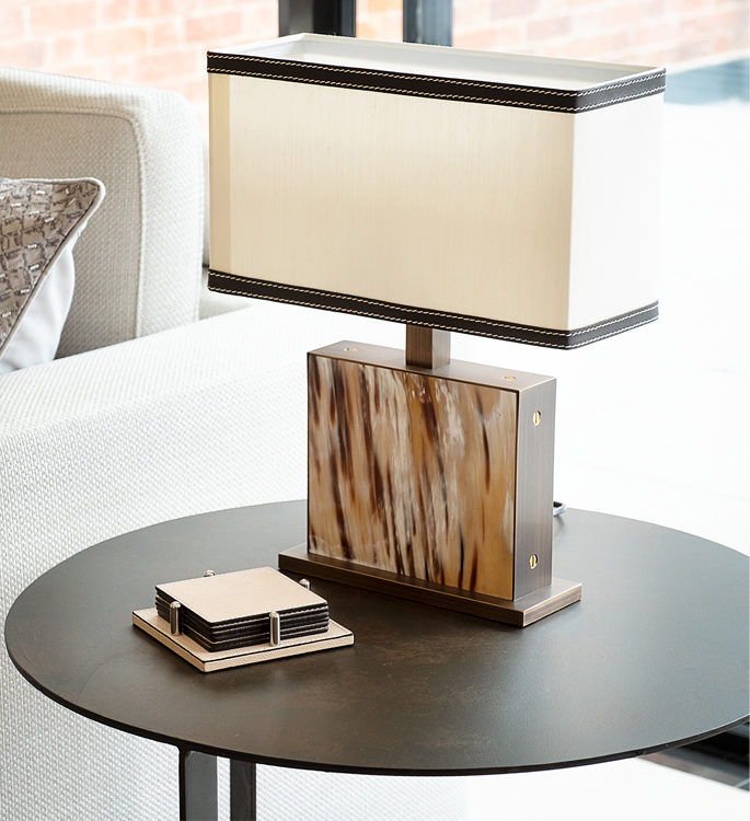 a small side table with a freestanding lamp made with natural horn materials