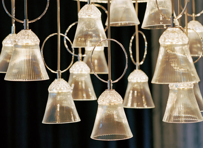 a multi-faced chandelier light that is glowing
