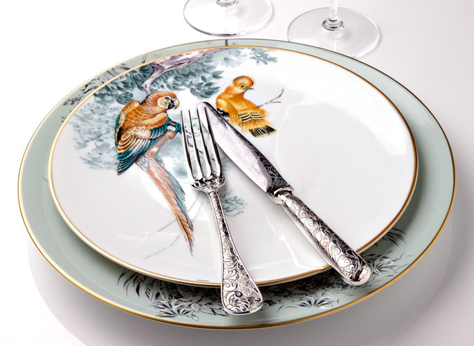 hermes porcelain plate with intricate decorative detail such as parrots in trees