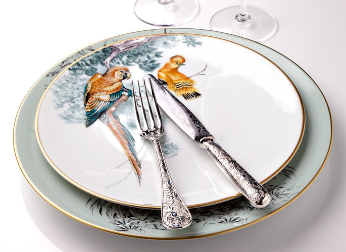hermes porcelain plate with intricate decorative detail such as parrots in trees