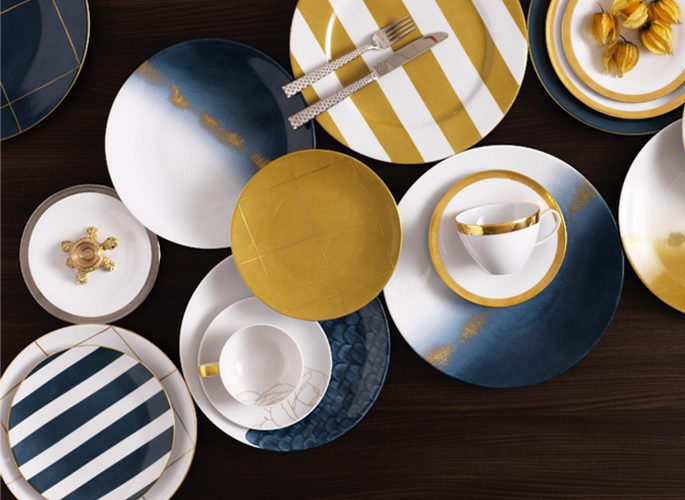 birdseye view of bright yellow and blue stripy porcelain plates