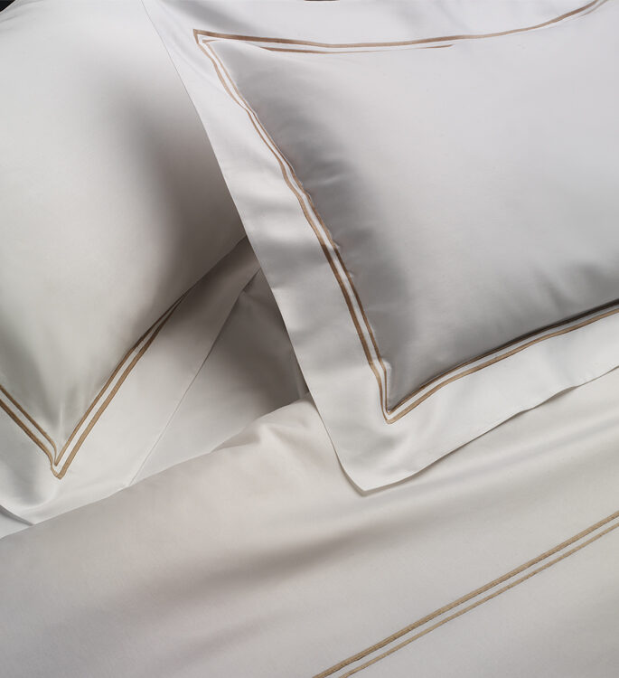 crisp oxford bordered pillows and bed linen with two embroidered lines